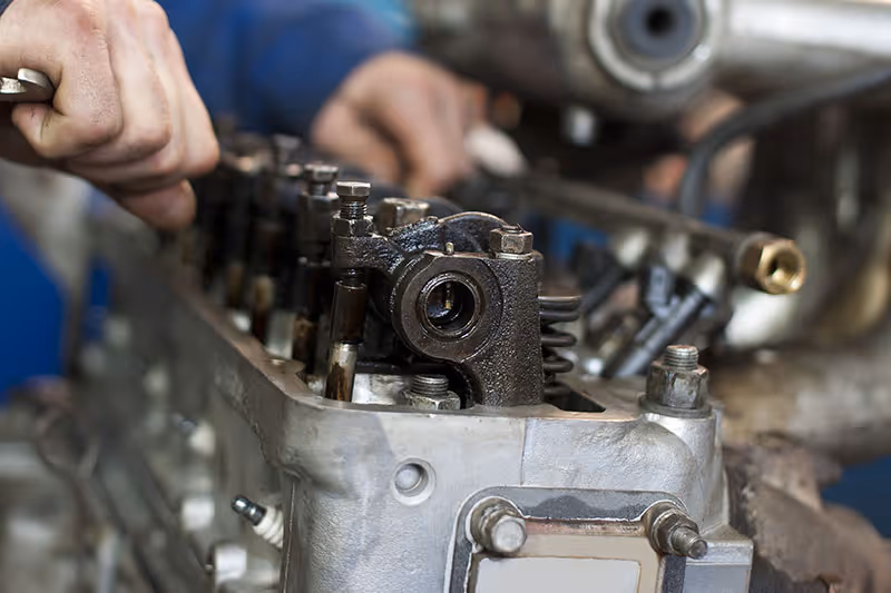 Vehicle engine being worked on by a qualified mechanic