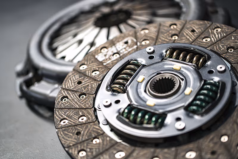 Clutch plate and transmission components during a professional gearbox repair in Masterton