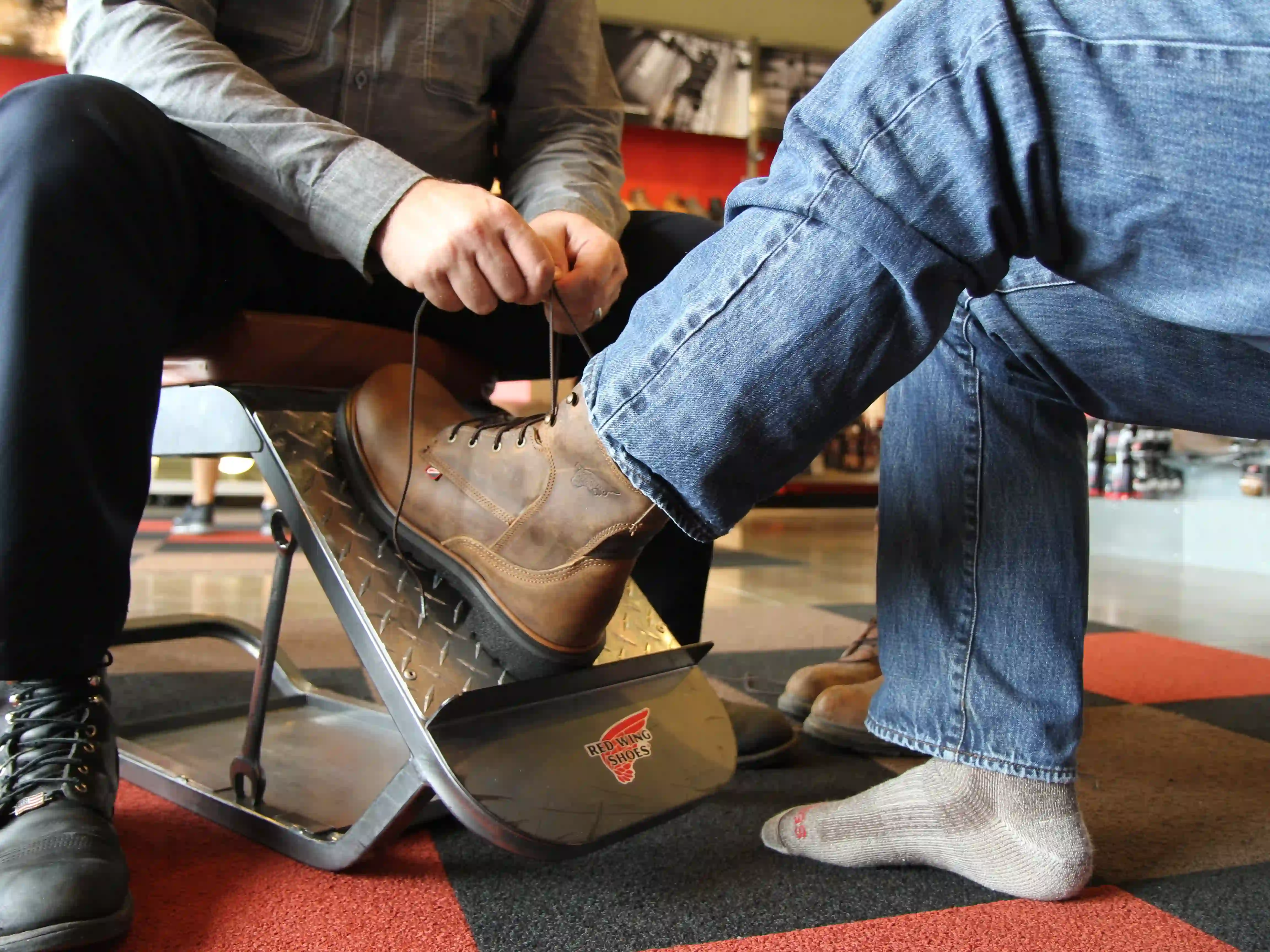 A work boot being fitted in store