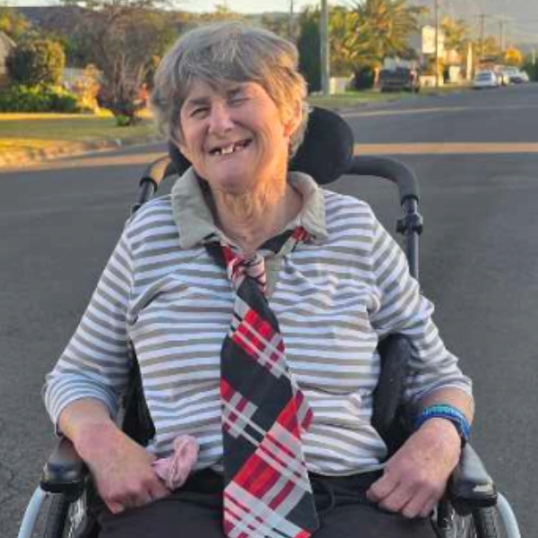 Participant Sandra smiling before going to dinner with her support worker
