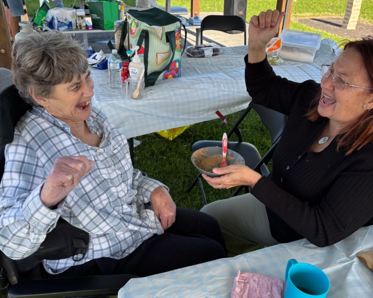 Sandra and her support worker enjoying some food
