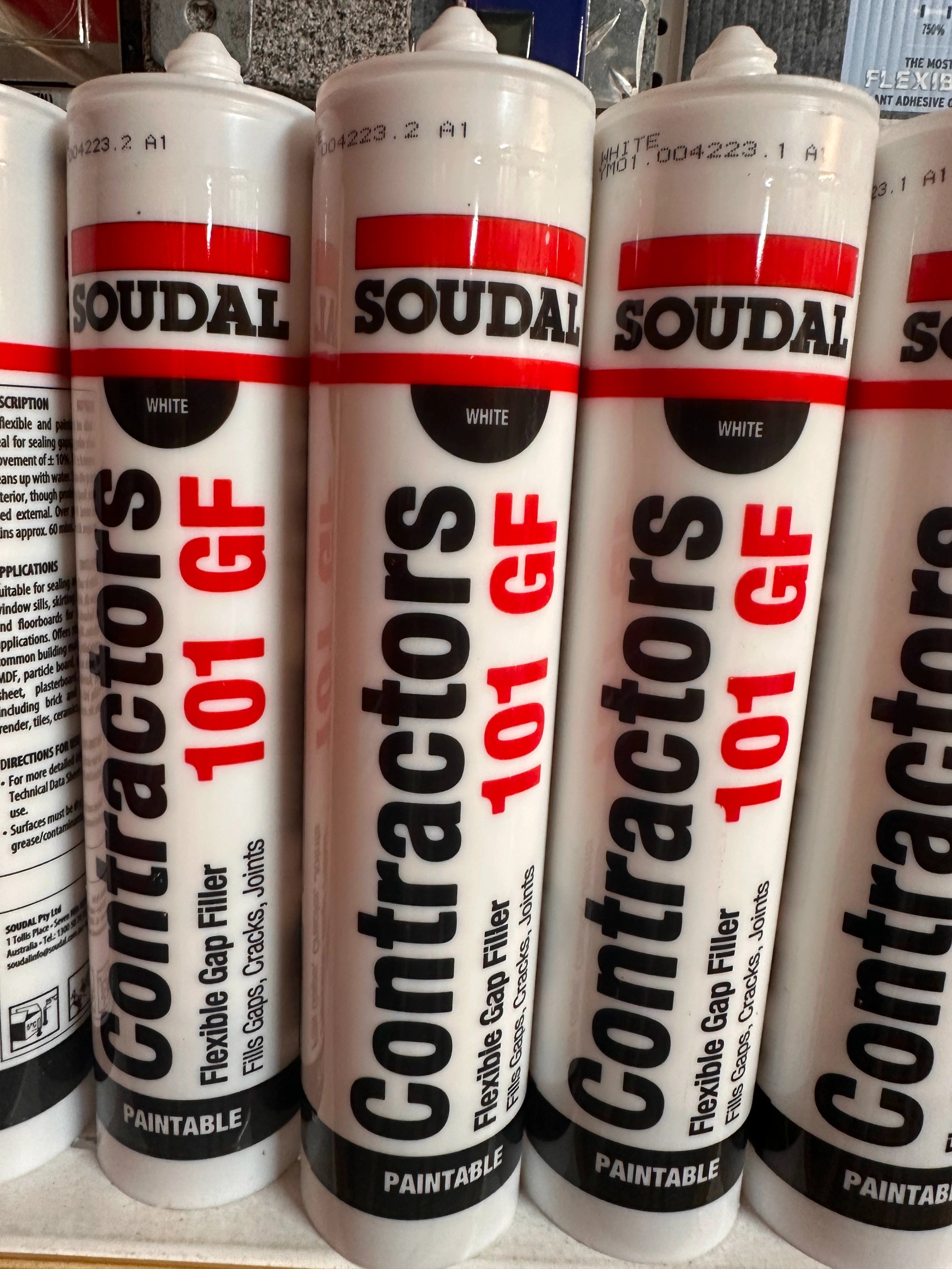 Several tubes of Soudal Contractors 101 GF flexible gap filler in white, labeled paintable and used for filling gaps, cracks, and joints.