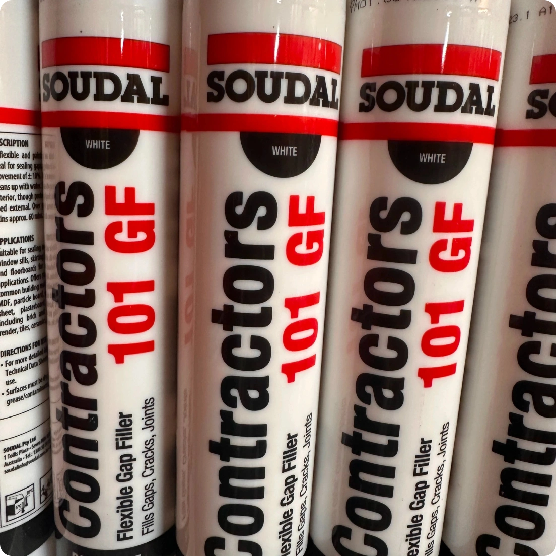 Close-up of multiple Soudal Containers 101 GF flexible gap filler tubes labeled white.