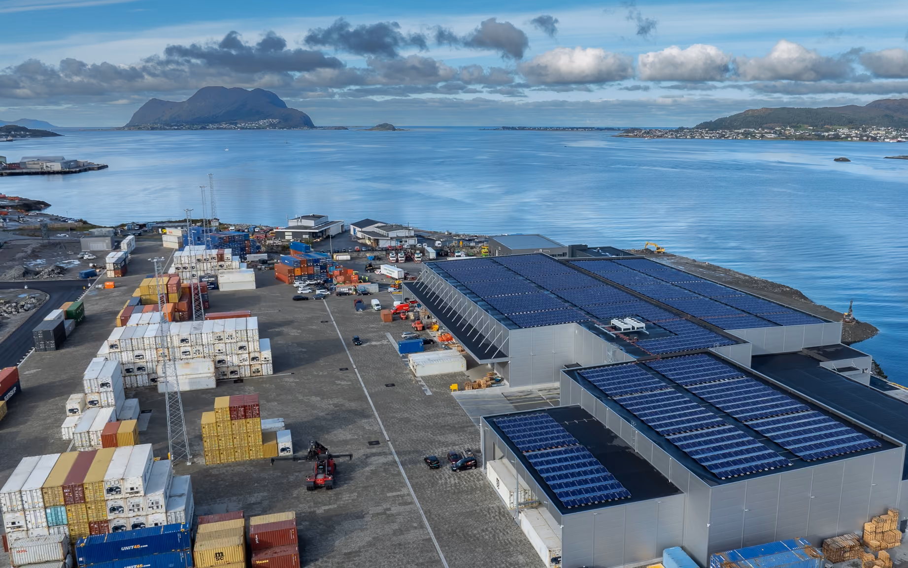 Aerial view of Flatholmen terminal, its solar-panel roofs and the surrounding fjord
