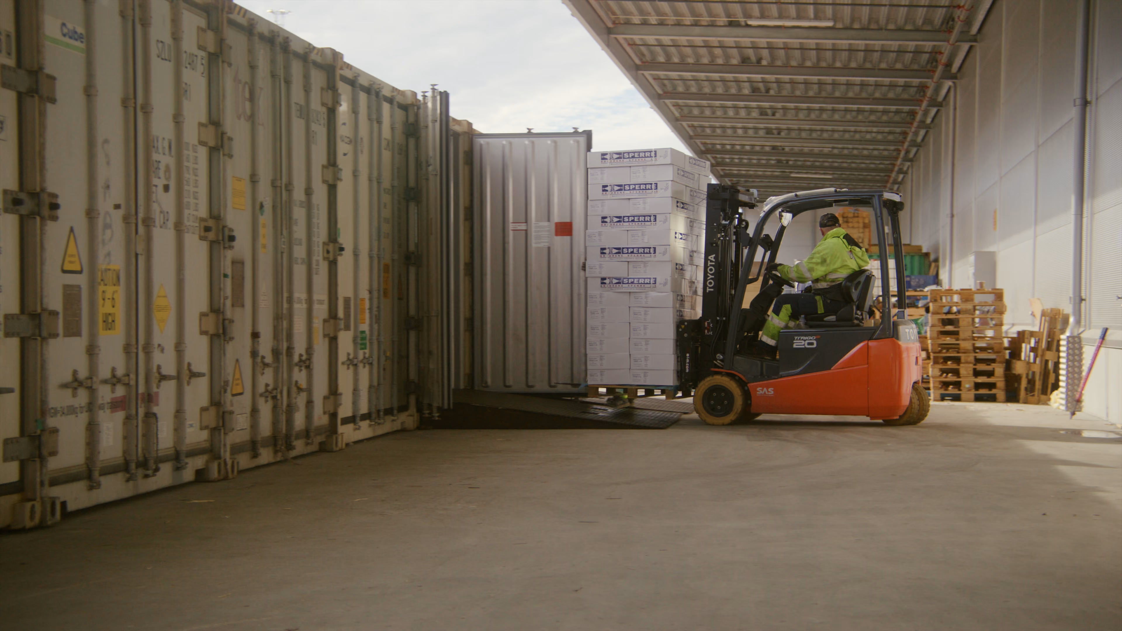 Forklift loading goods into a semi-trailer at the loading bay