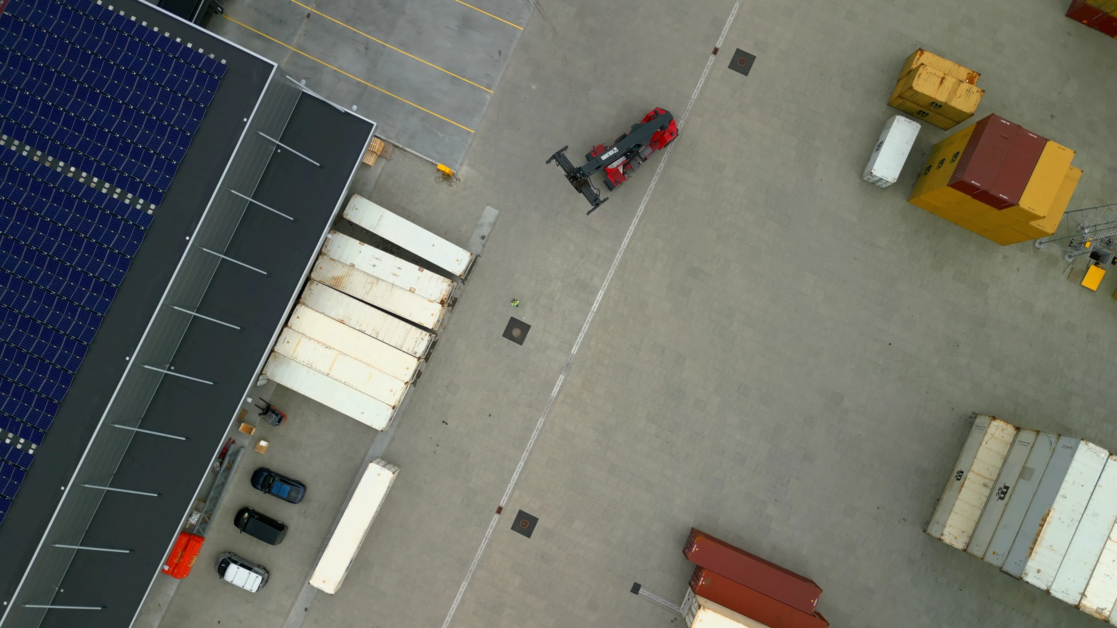 Overhead view of vehicles and cargo in the terminal yard