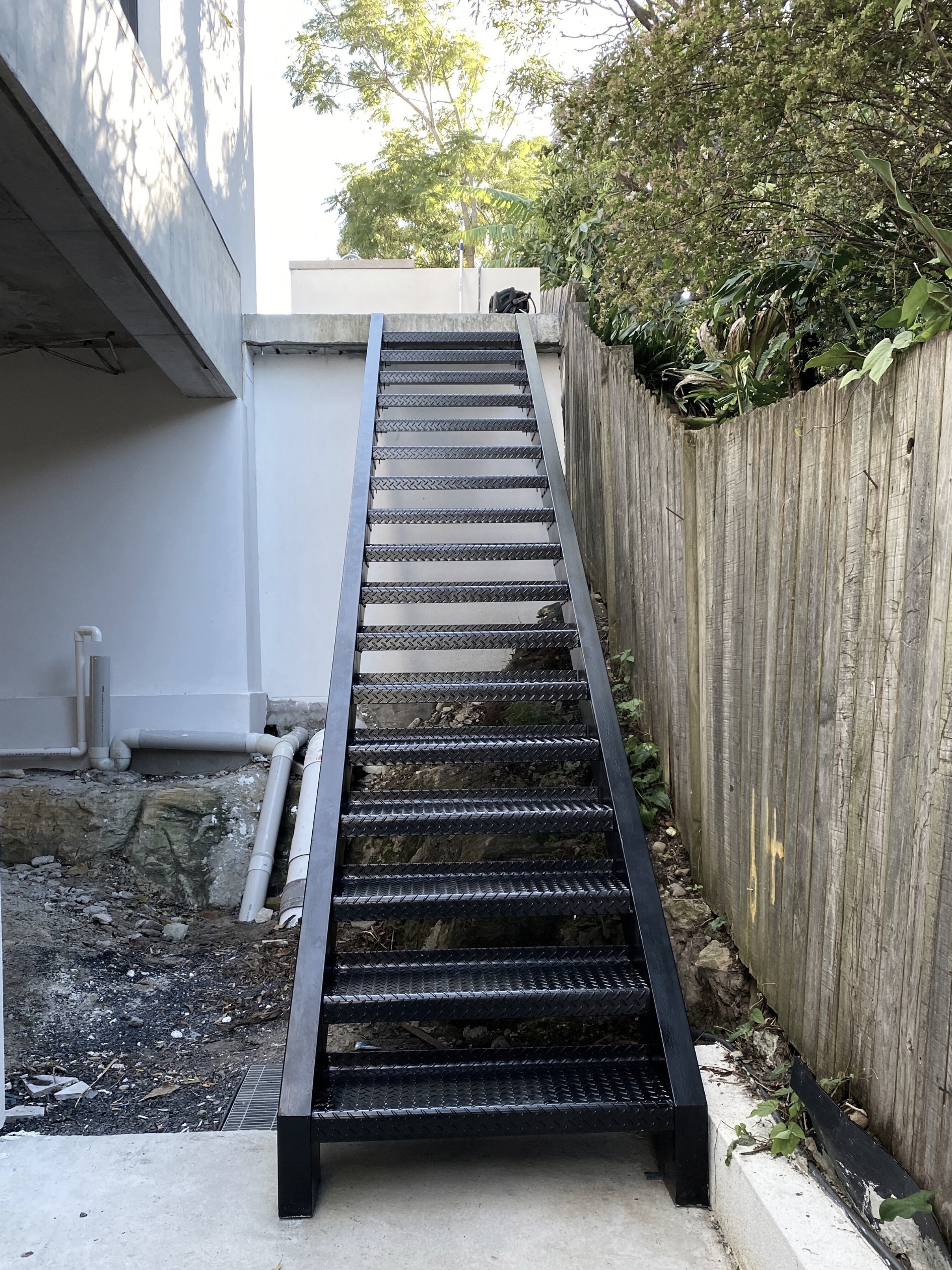 Exterior black steel staircase by INOX Construction