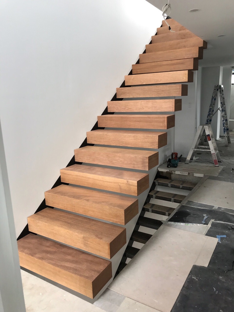 Thick oak floating staircase by INOX Construction