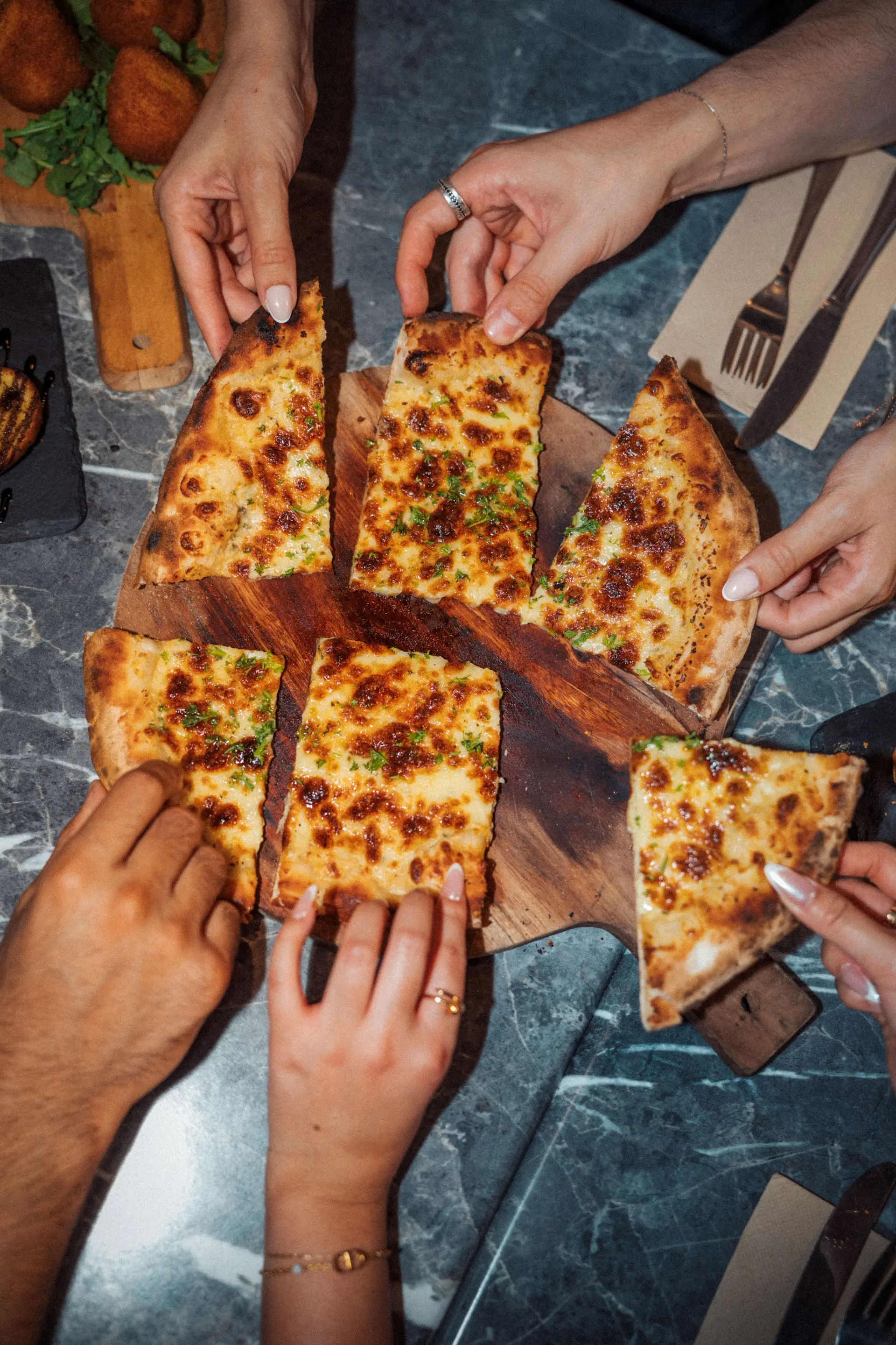 Pizza catering service with woodfired pizzas served for events, parties, and group dining.