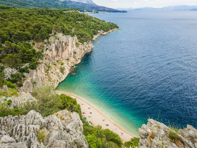 Aerial shot of Croatian coastline with beautiful white rocks and deep blue sea