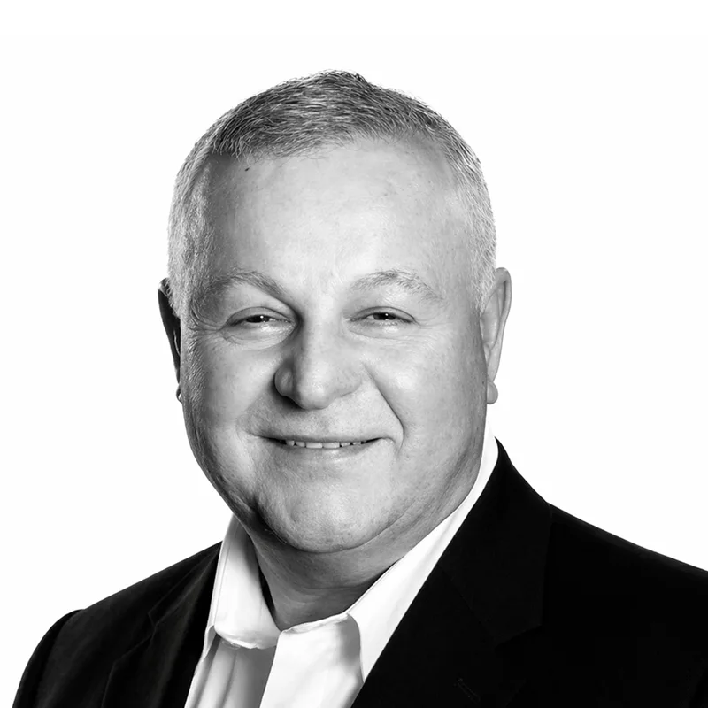 A black and white headshot of Dr. Kam Ghaffarian.