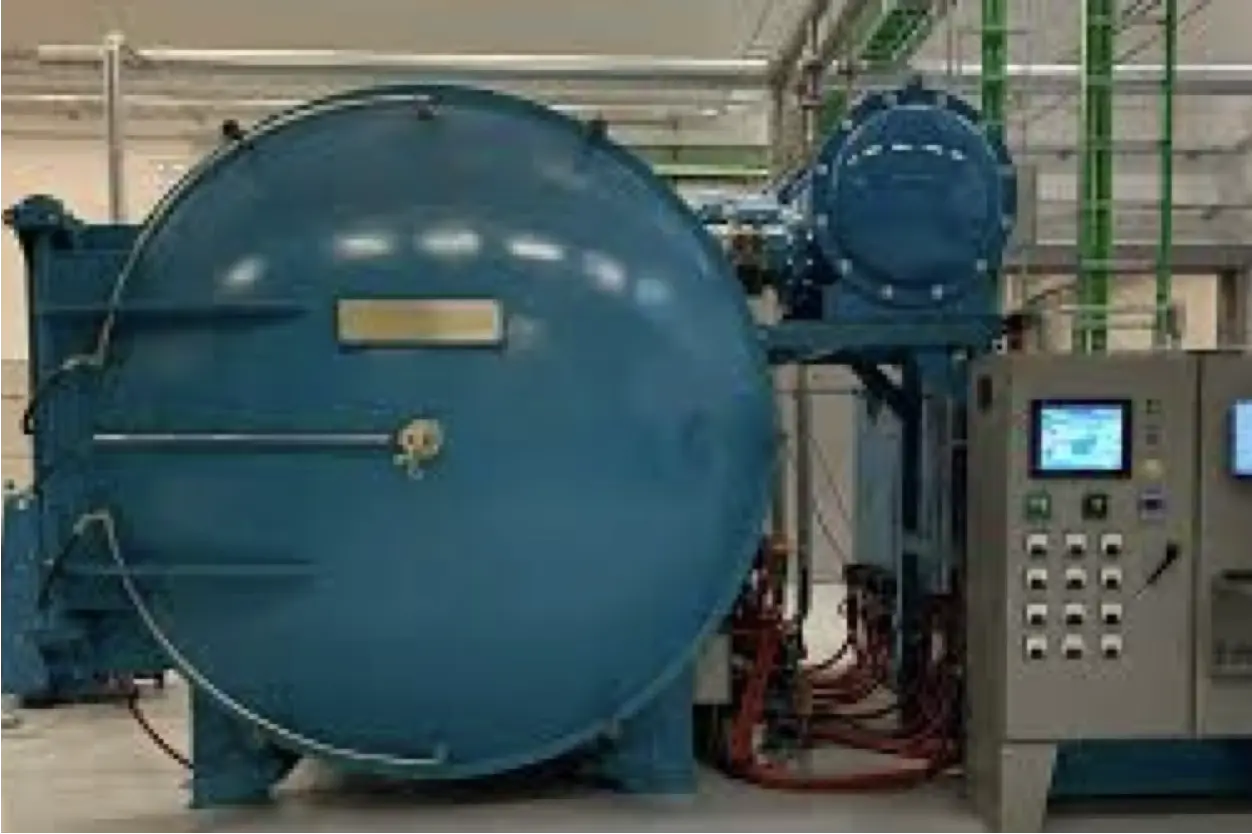 Large blue industrial machine with control panel and display screens inside a factory setting.