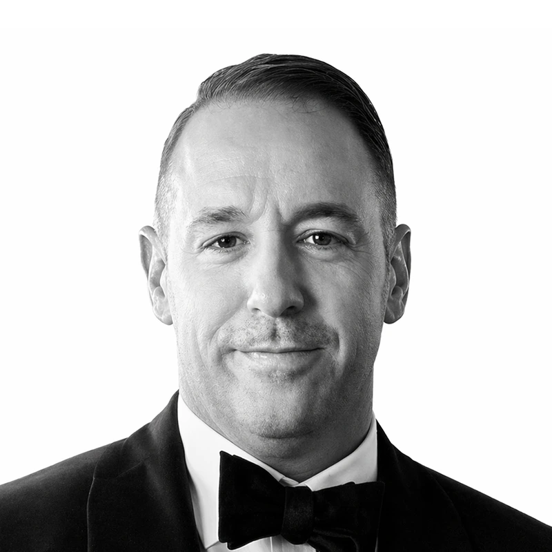 A black and white headshot of Dustin Berra.