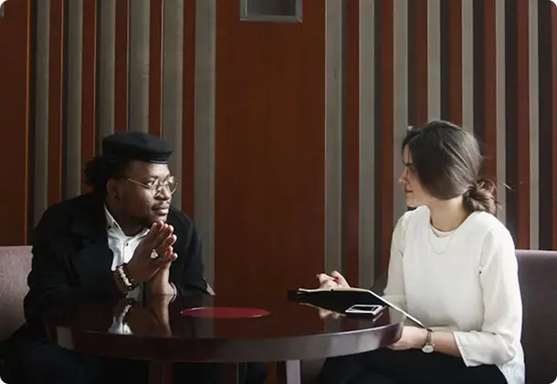 Two people in conversation at a small table