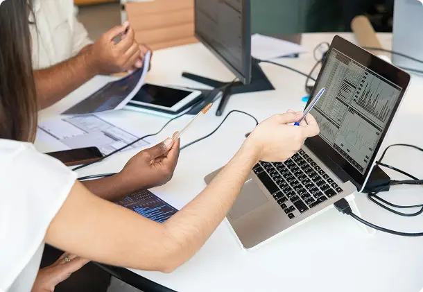 Colleagues working together on a laptop at a table