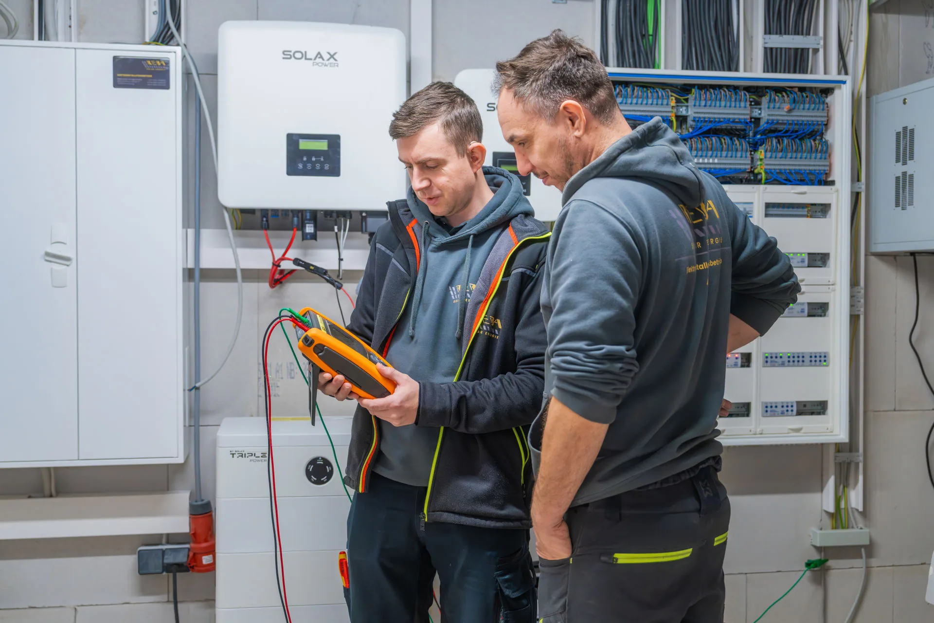 Zwei Mitarbeiter von Reba Solar prüfen die Energieeffiziens einer Anlage bei einem Kunden.