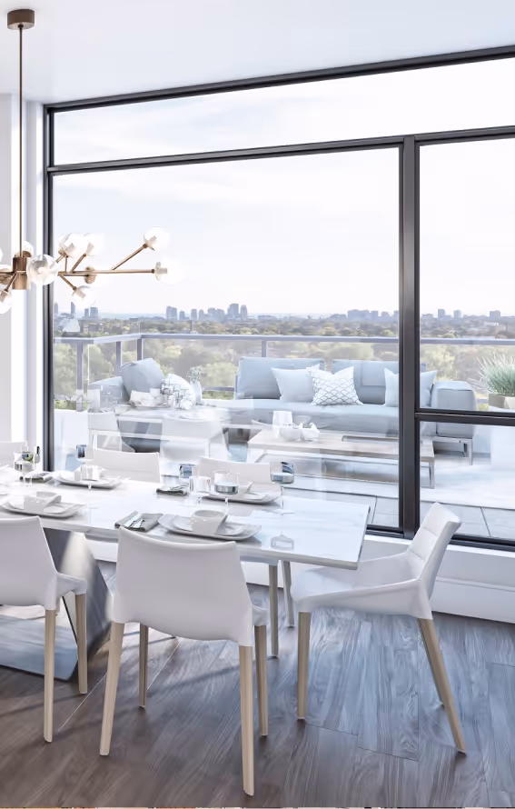 Modern dining area with white chairs and table, large windows showing outdoor lounge and city views.