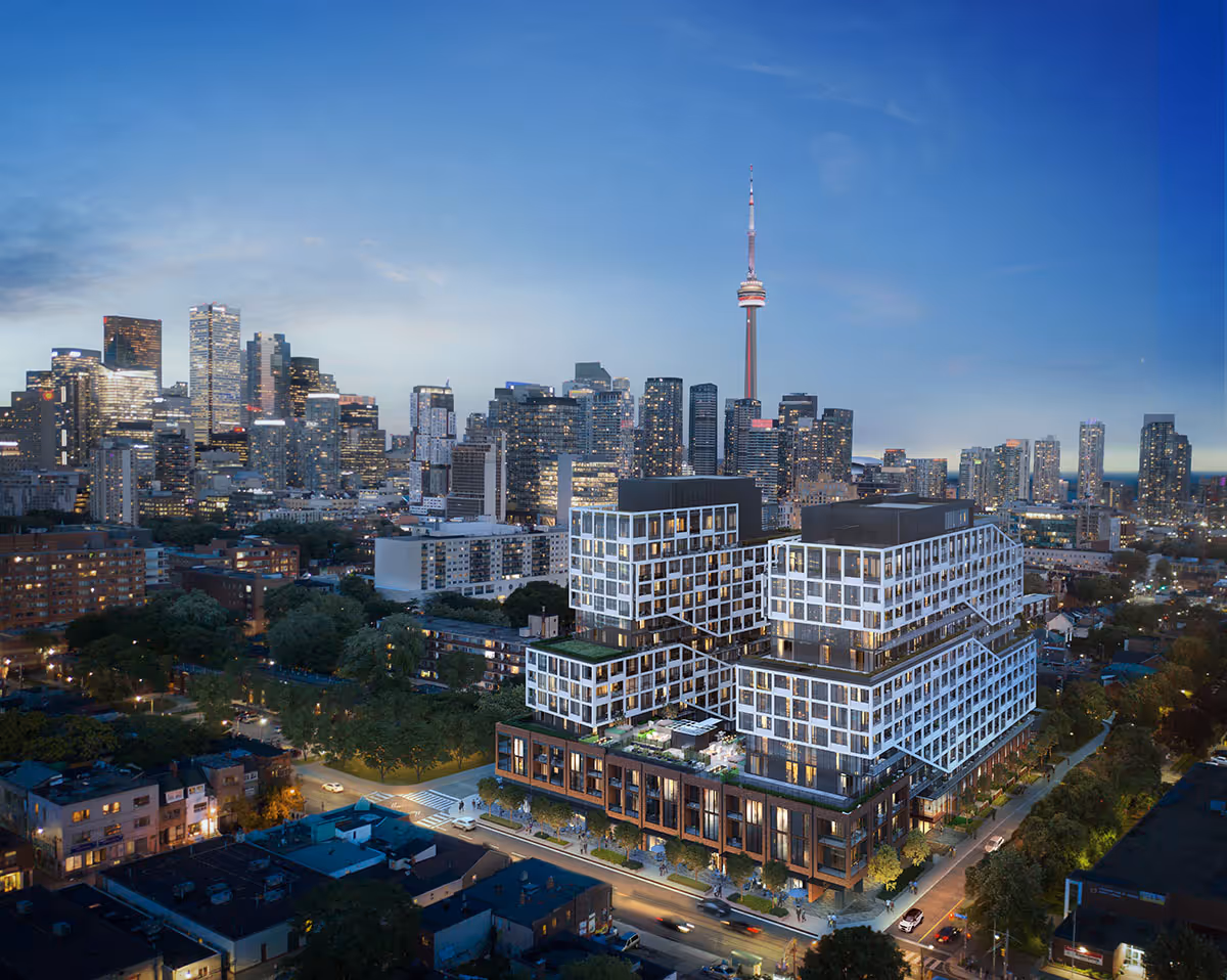 Modern multi-level building with city skyline and CN Tower in the background at dusk.
