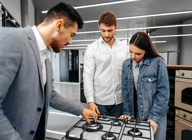 Kitchen showroom assistant helping a couple choose a kitchen