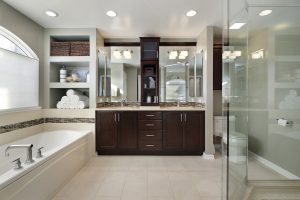 Master bath in luxury home with dark wood cabinetry