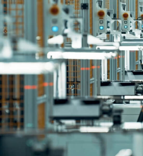 Close-up view of automated robotic arms and machinery in a high-tech manufacturing facility.