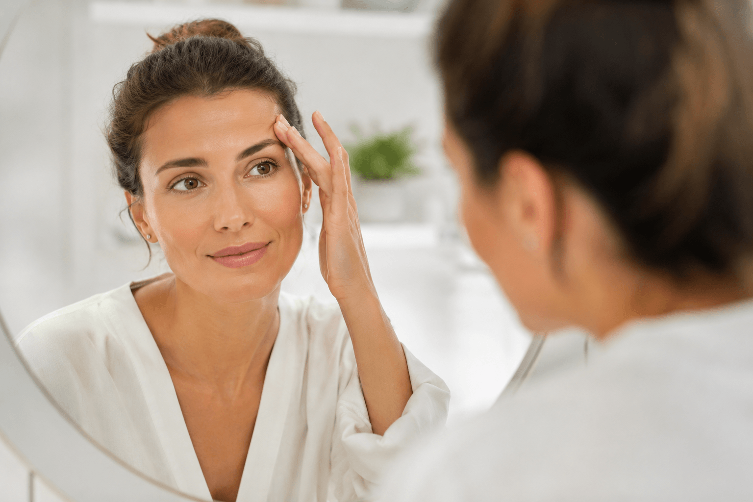 Patient consulting with an aesthetic provider about Botox, dermal fillers, PRP, and Sculptra treatment options at an aesthetic clinic in San Diego, California.