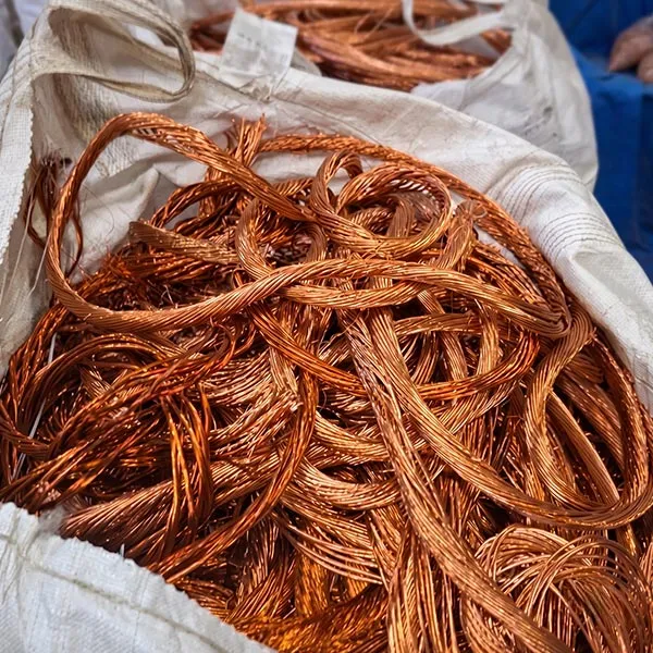 Fios de cobre entrelaçados dentro de um saco branco, representando sucatas de metais não ferrosos.