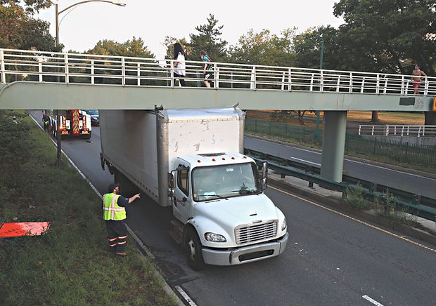 Truck getting stuck under a bridge