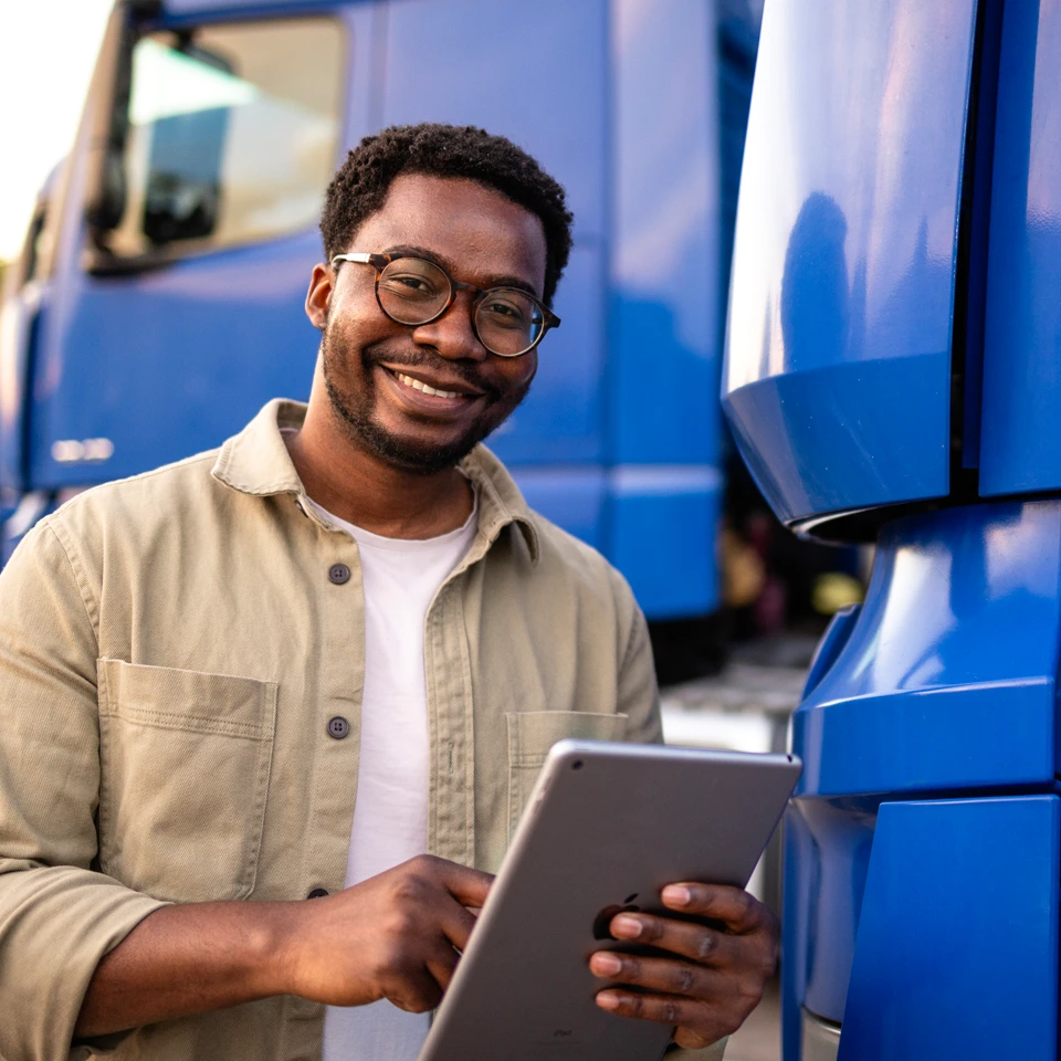 Truck driver using transportation management software on tablet