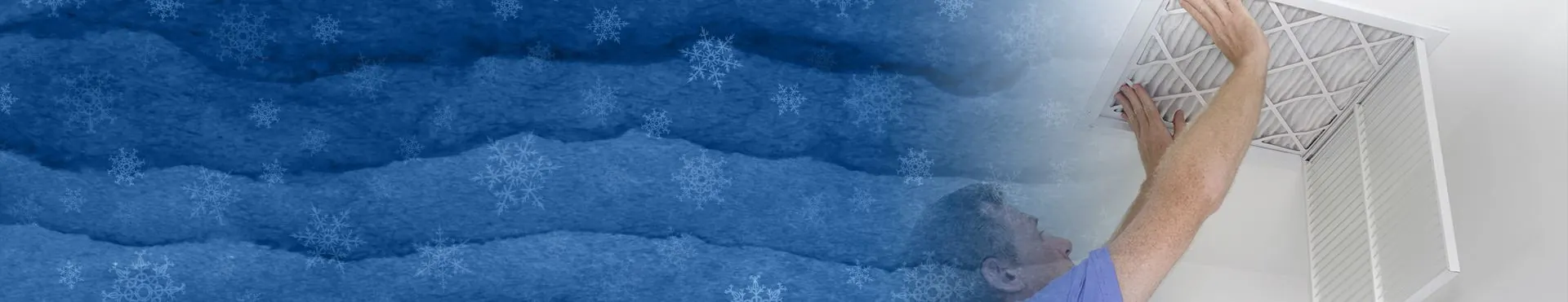 Person changing a ceiling air filter with a blue background decorated with snowflakes.