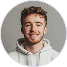 A man with curly hair and a beard wearing a white hoodie.