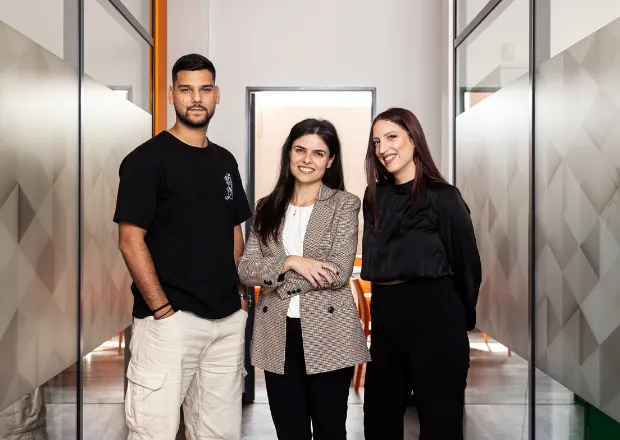 Three professionals posing in modern office, Circet Energy team members showcasing energy infrastructure expertise.