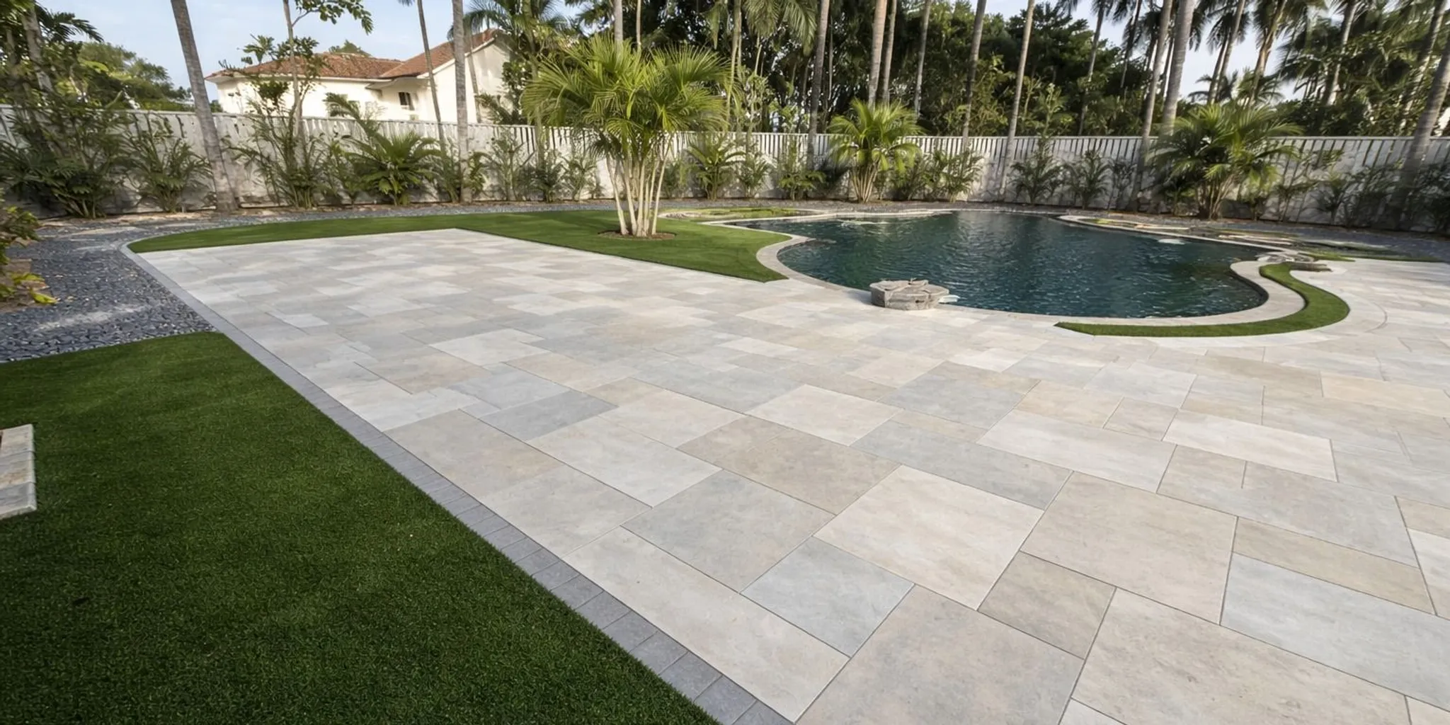 Modern Florida patio with large-format travertine-look porcelain pavers and pool deck