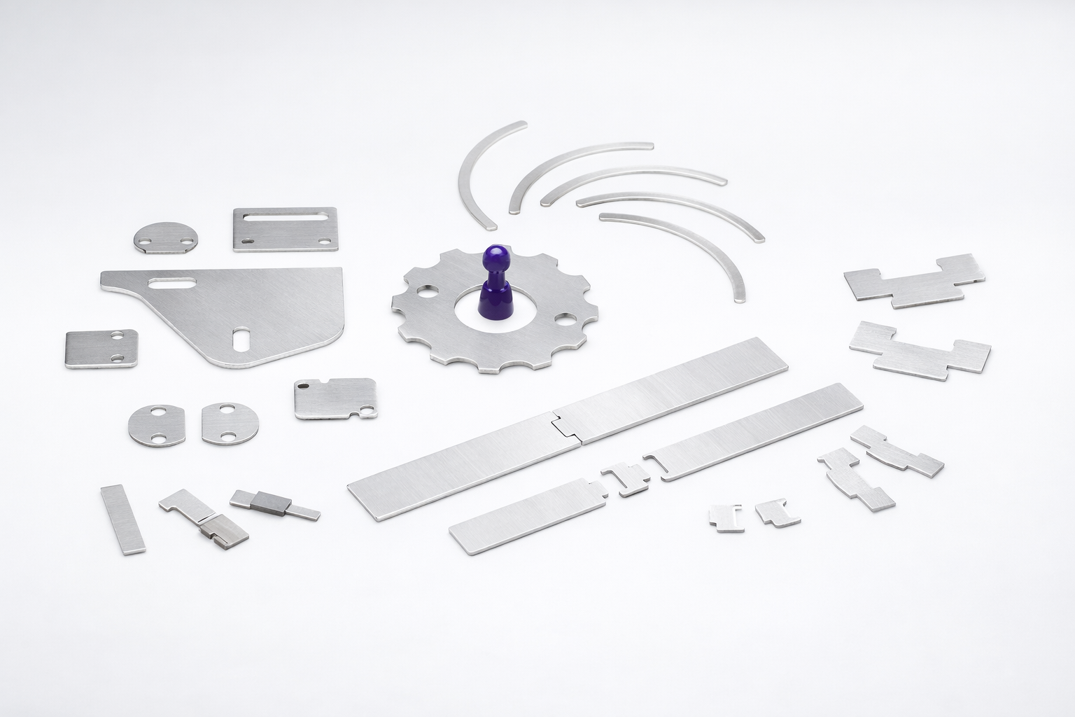 Various flat, silver-colored metal parts and a single purple plastic peg arranged on a white background.
