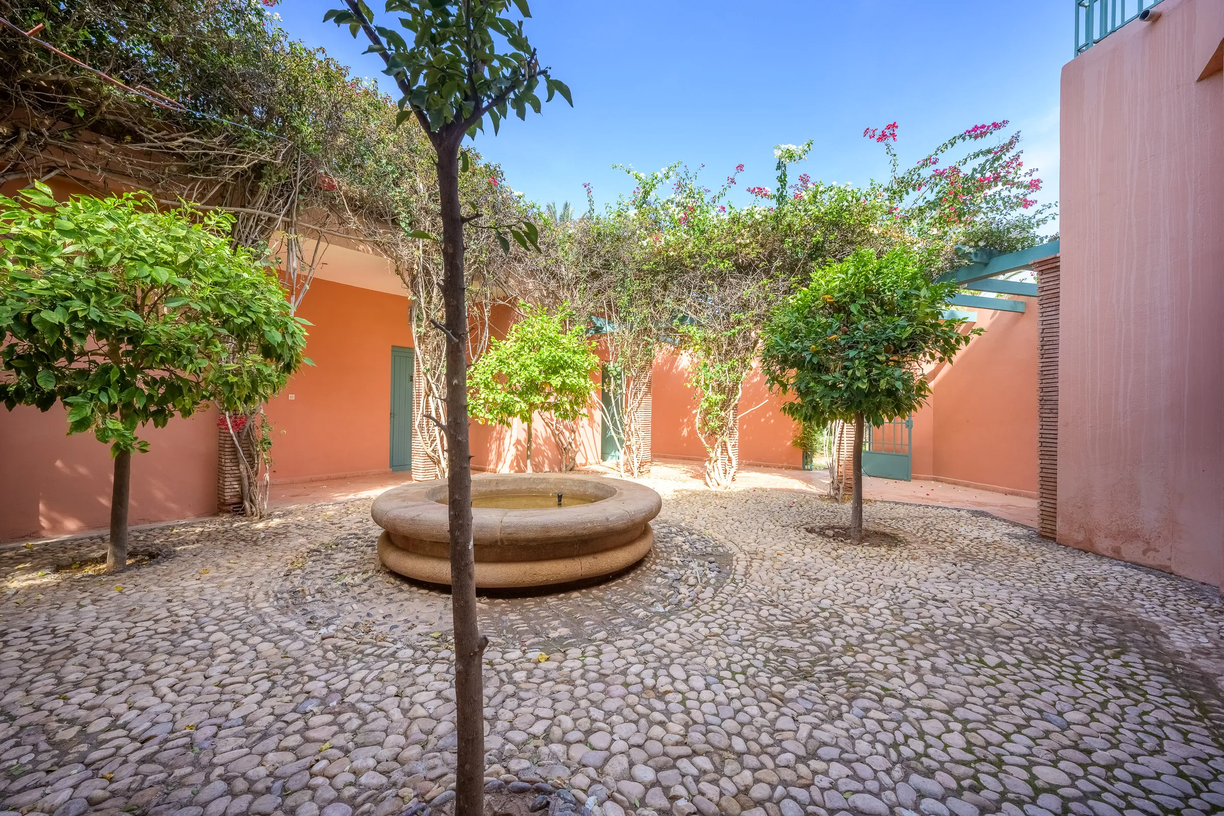 Courtyard with fountain and bougainvillea in a Marrakech villa