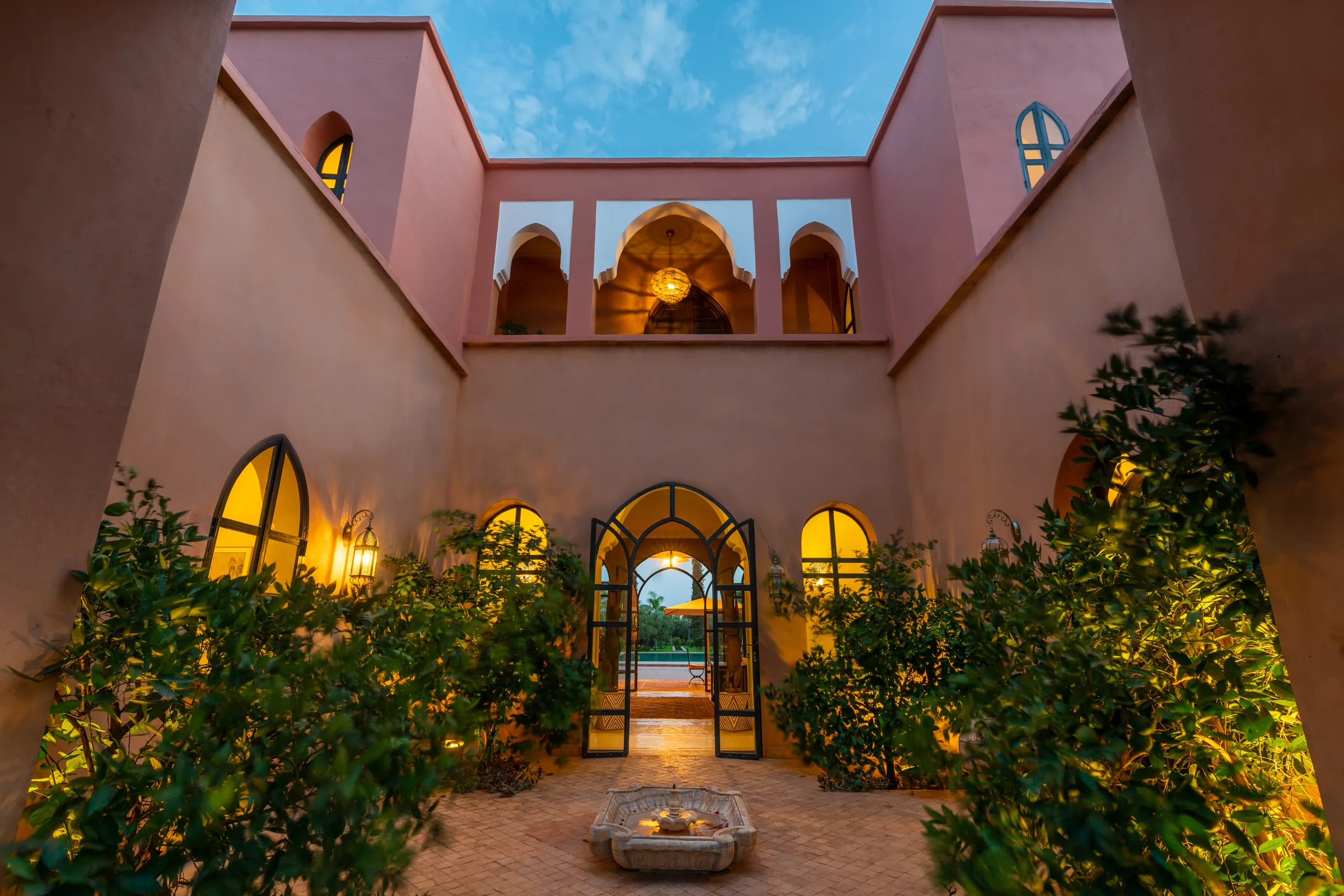 Courtyard of a private villa at dusk in Marrakech