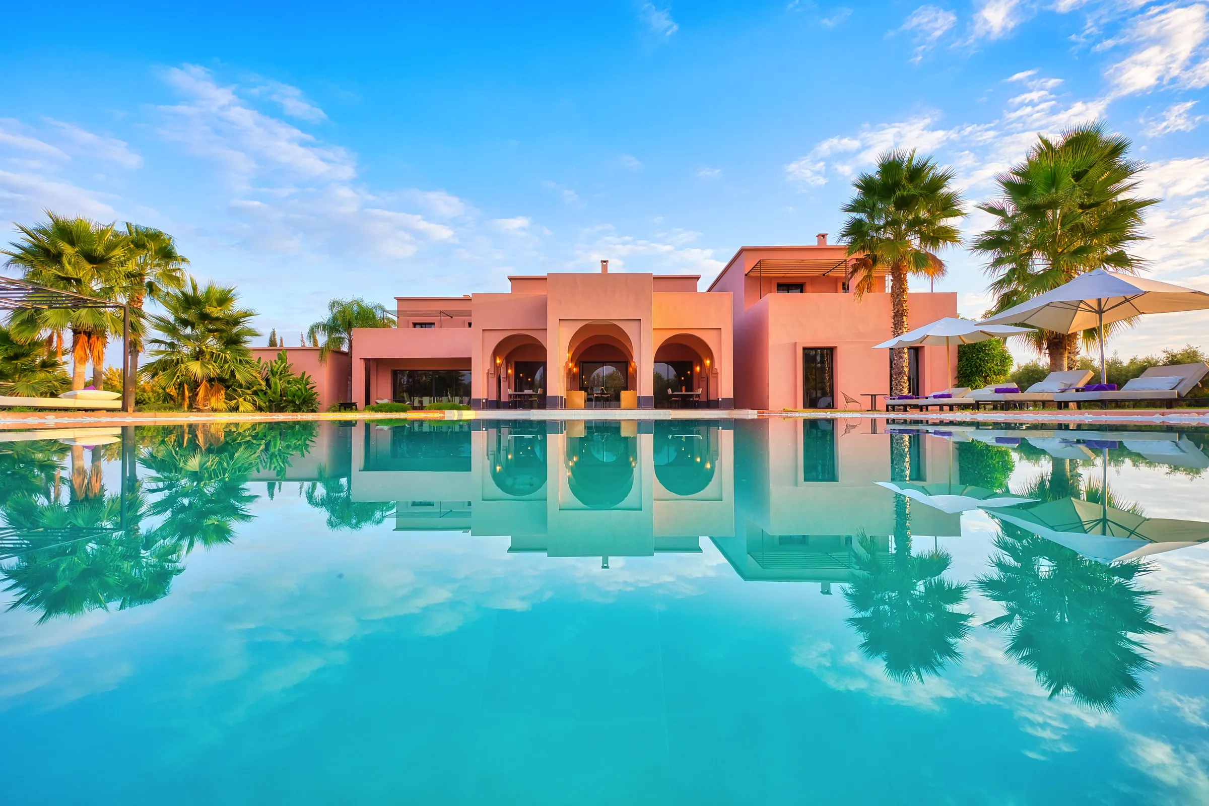 Pool and pink facade of a private villa near Marrakech
