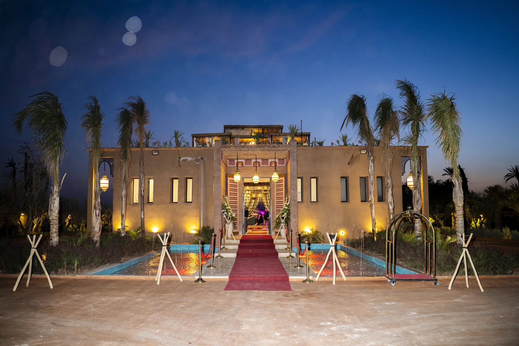Villa Moira, celebration villa in the Palmeraie, Marrakech, gala entrance illuminated for a celebration. The Marrakech Curator.