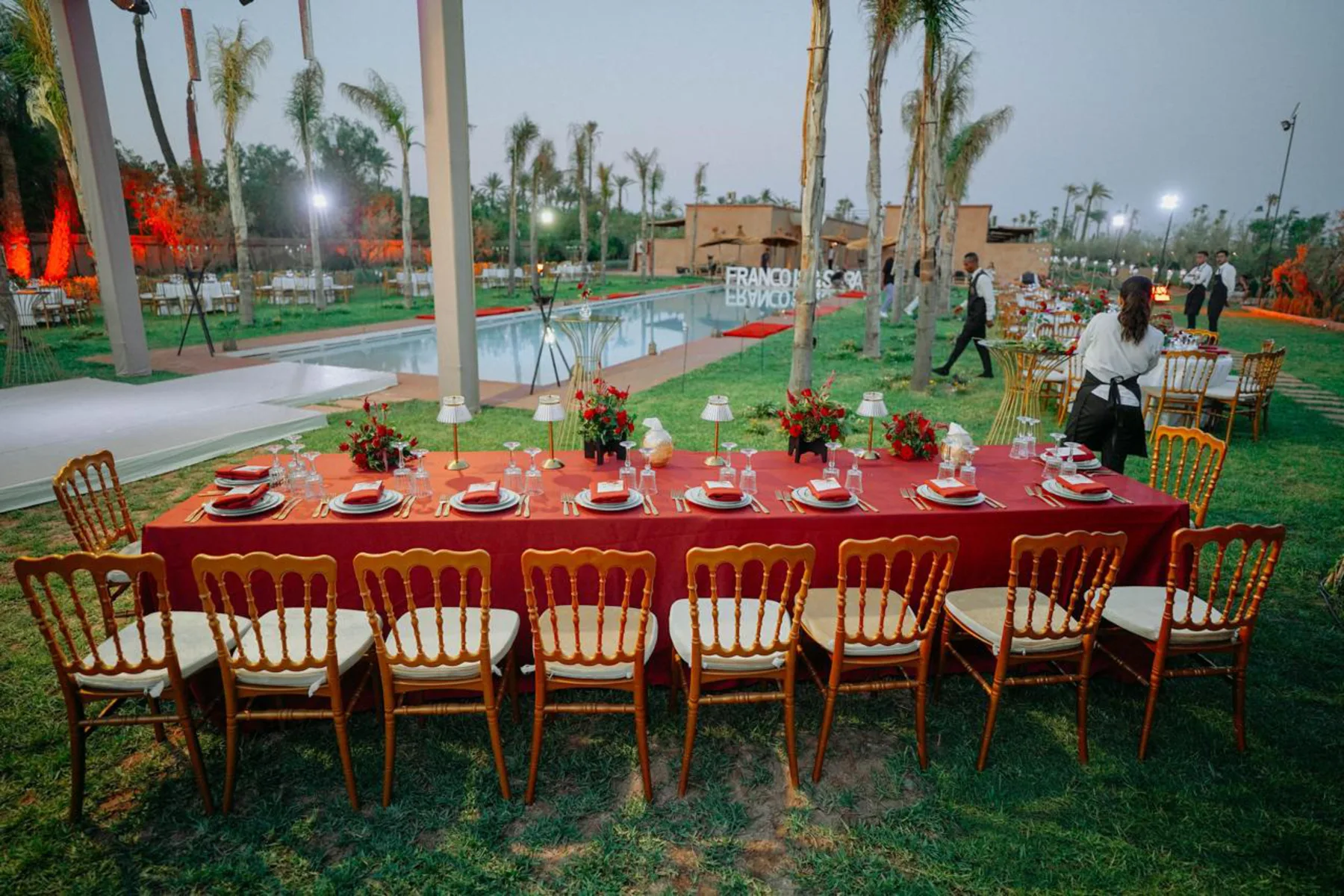 Villa Moira, celebration villa in the Palmeraie, Marrakech, grand banquet table dressed in the gardens. The Marrakech Curator.