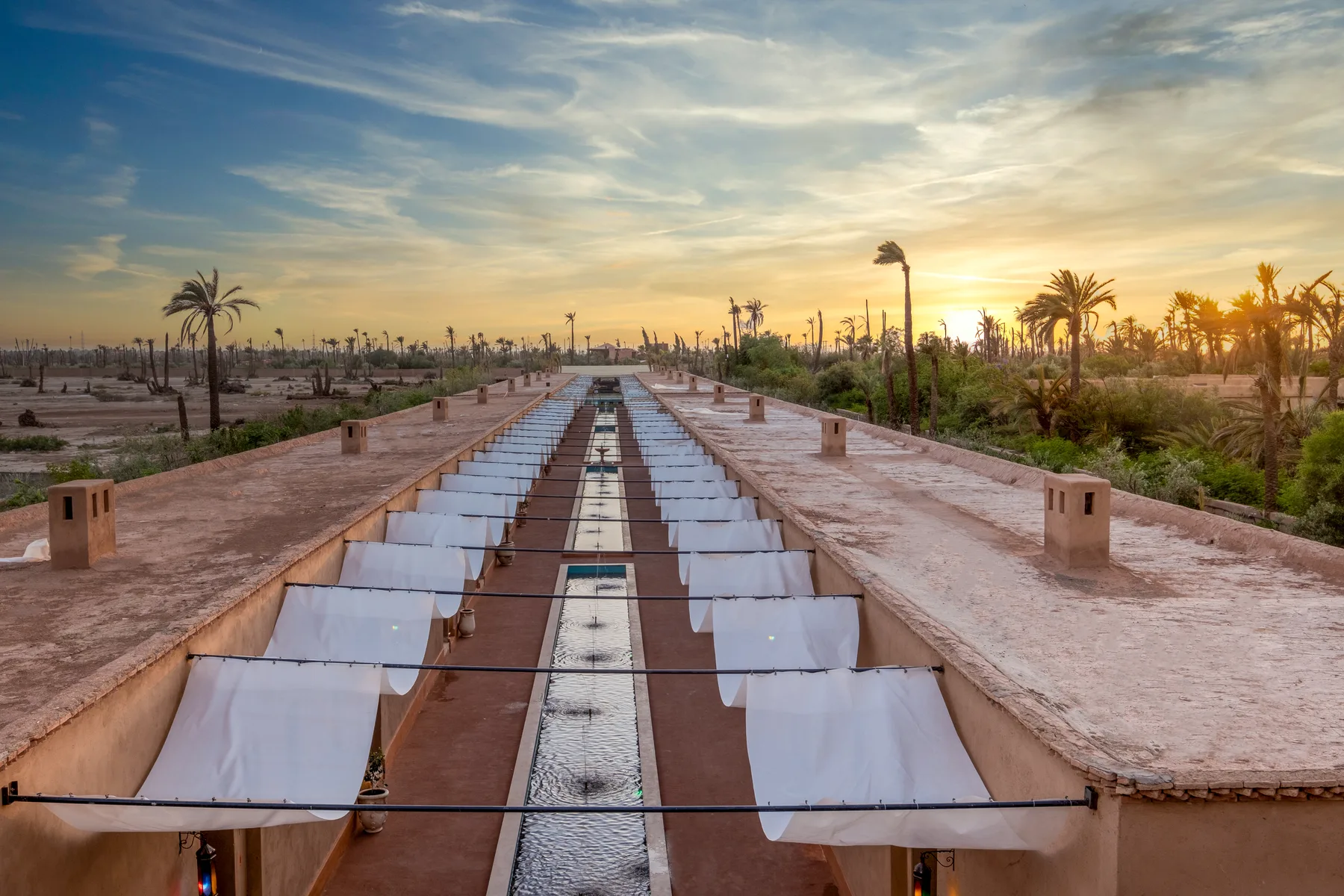 Villa Moira, celebration villa in the Palmeraie, Marrakech, sunset over the Palmeraie. The Marrakech Curator.