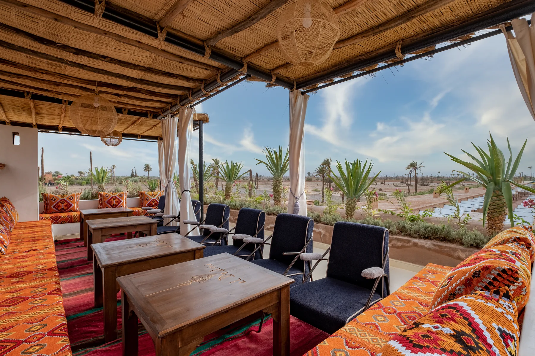 Villa Moira, celebration villa in the Palmeraie, Marrakech, rooftop lounge dressed with kilims. The Marrakech Curator.