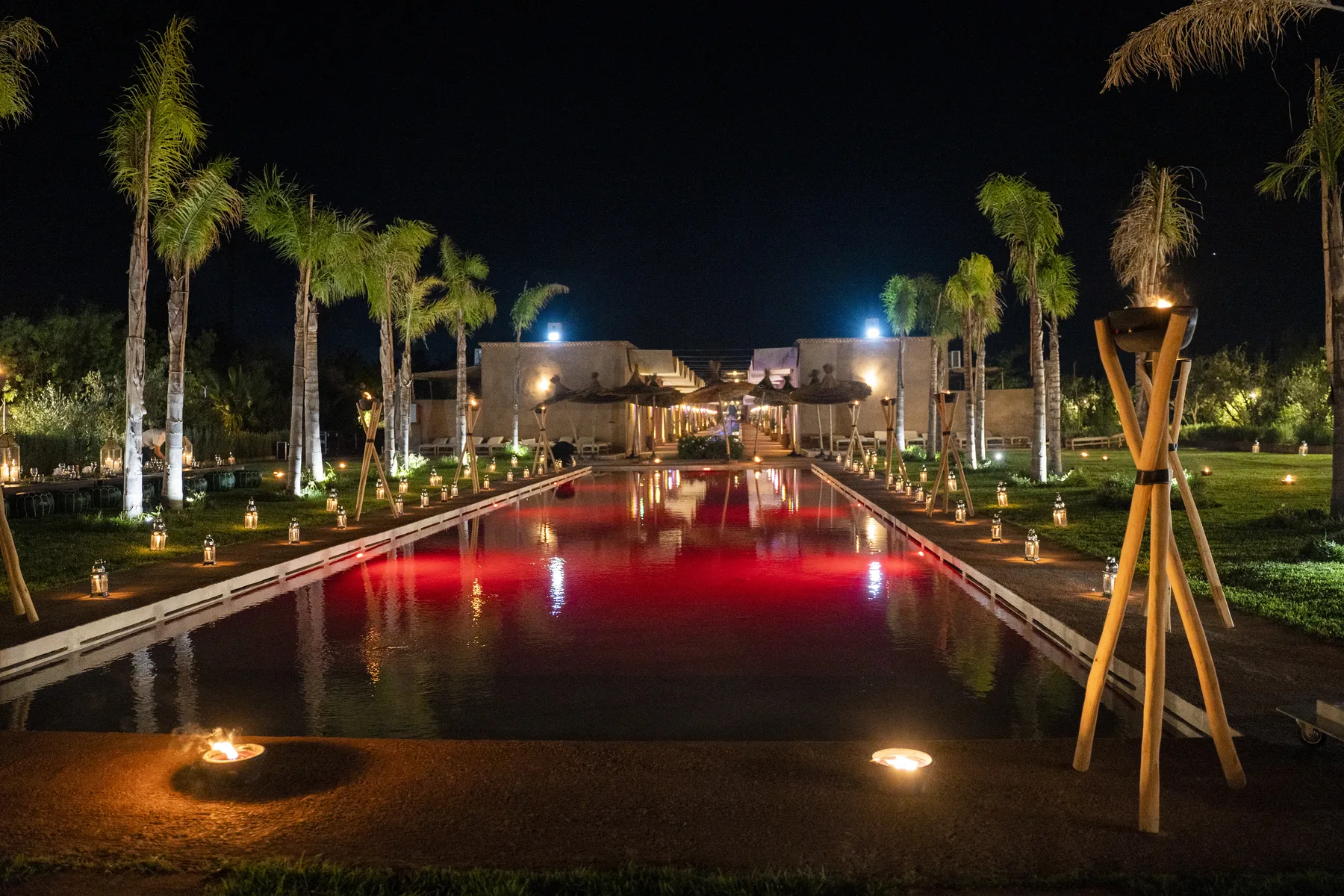 Villa Moira, celebration villa in the Palmeraie, Marrakech, poolside event lighting at night. The Marrakech Curator.