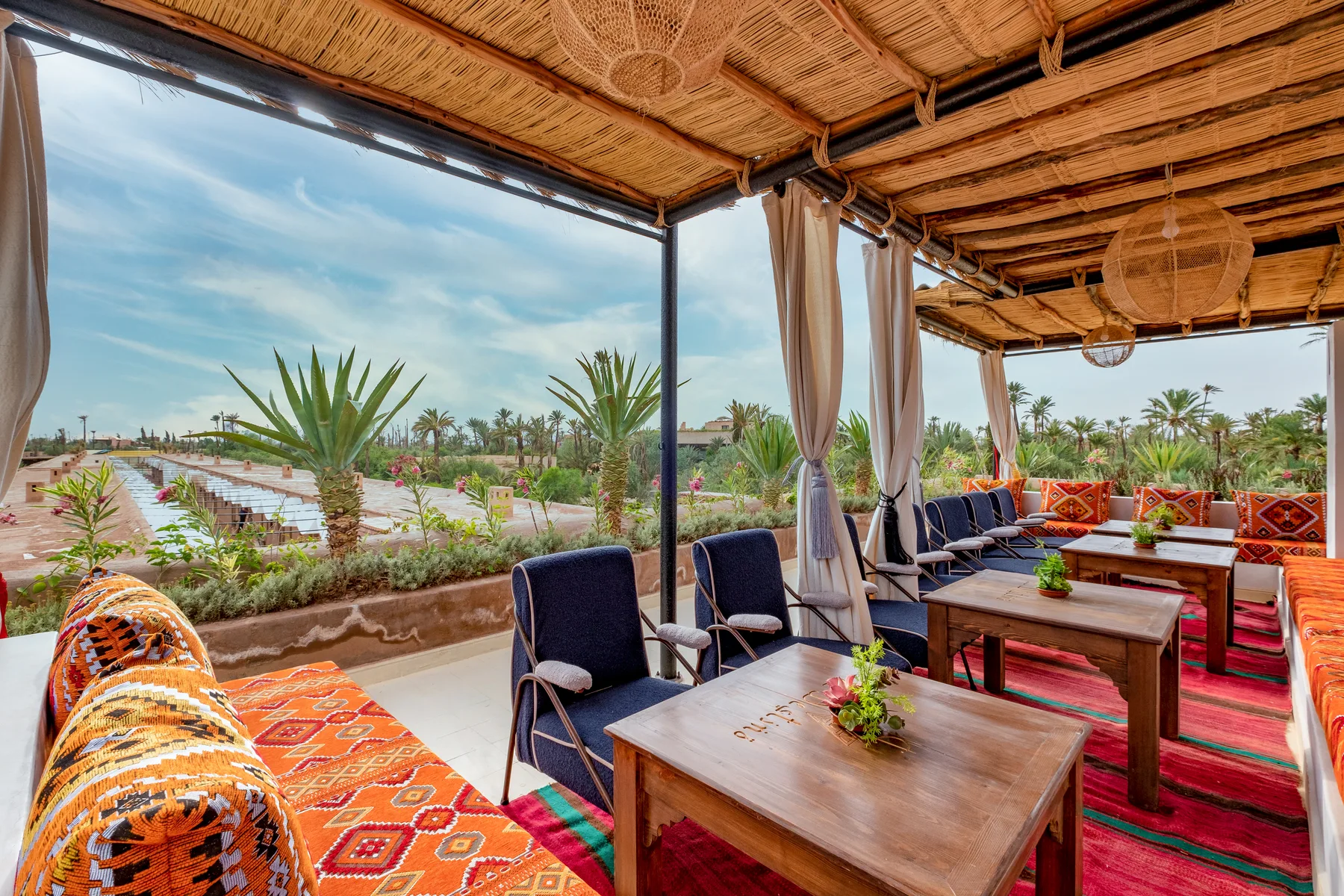 Villa Moira, celebration villa in the Palmeraie, Marrakech, rooftop dining terrace over the palm grove. The Marrakech Curator.