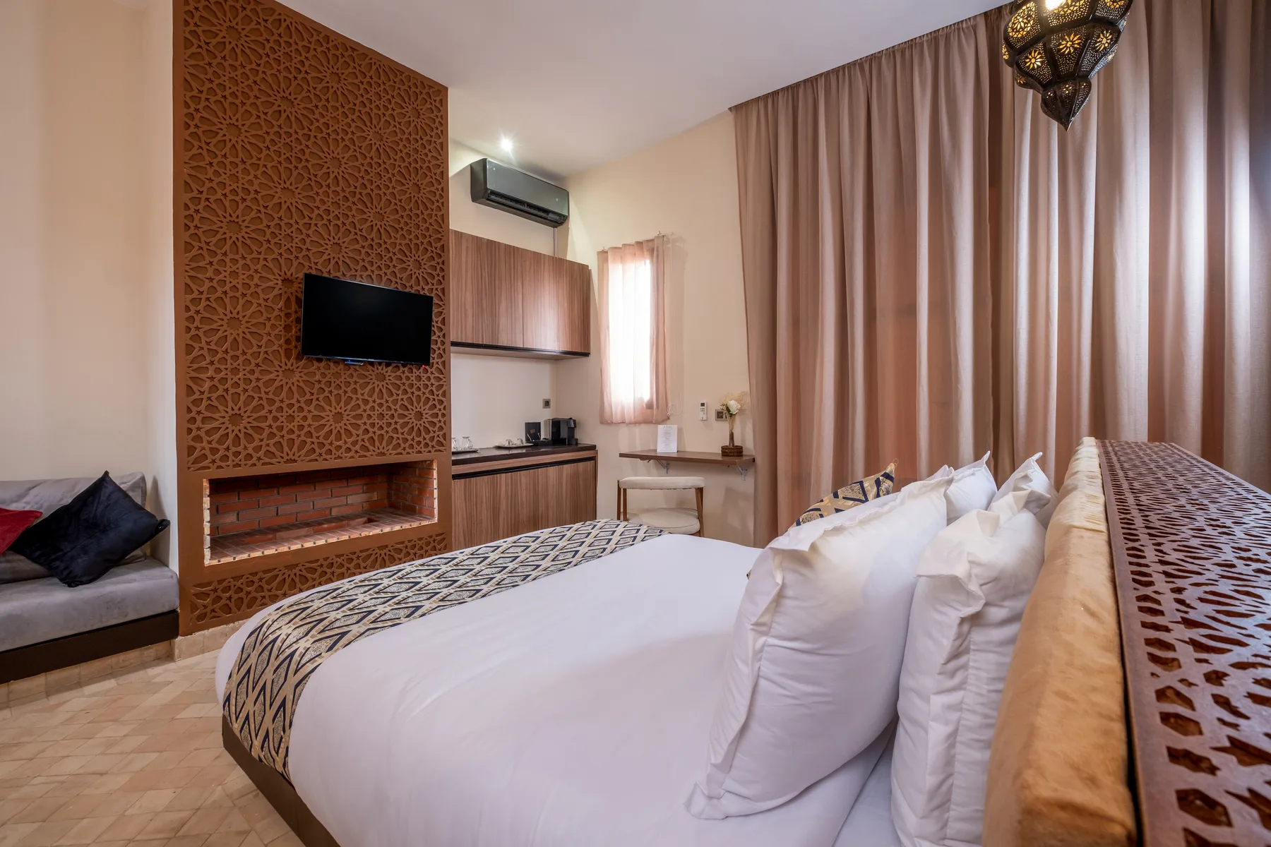 Villa Moira, celebration villa in the Palmeraie, Marrakech, suite bedroom with fireplace. The Marrakech Curator.