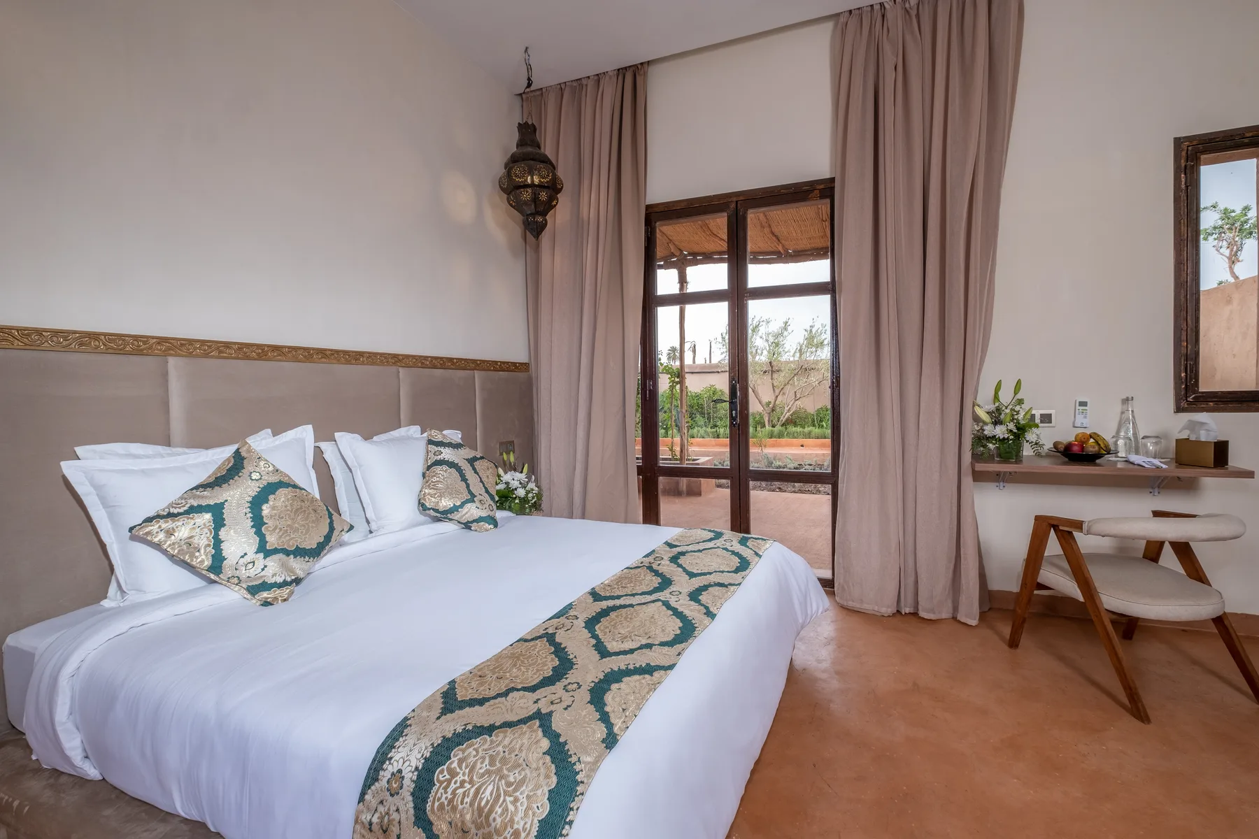 Villa Moira, celebration villa in the Palmeraie, Marrakech, garden-view bedroom. The Marrakech Curator.