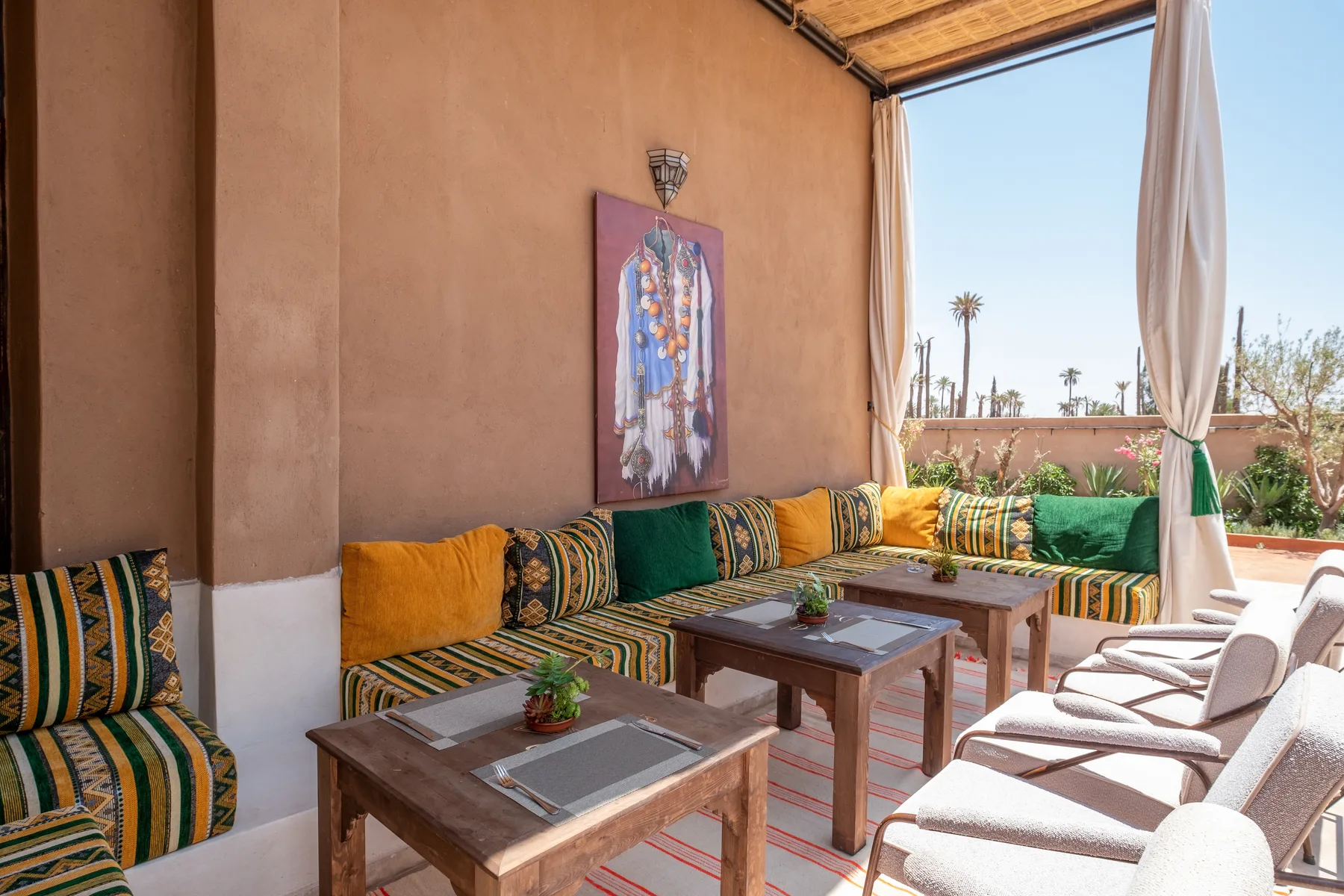 Villa Moira, celebration villa in the Palmeraie, Marrakech, lounge corner with Moroccan art. The Marrakech Curator.