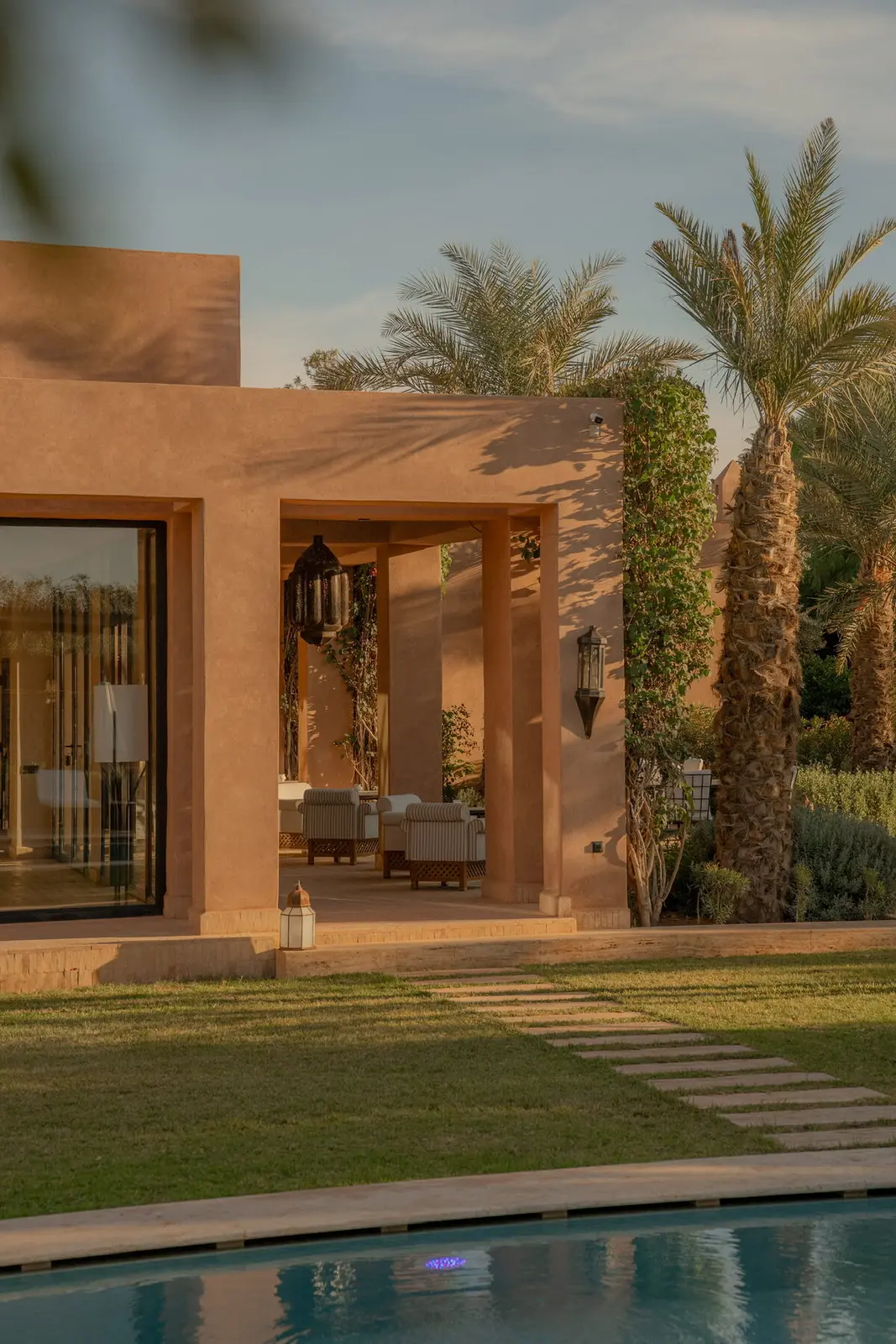 Villa Pegasos, private estate near Marrakech, facade reflected in the pool. The Marrakech Curator.