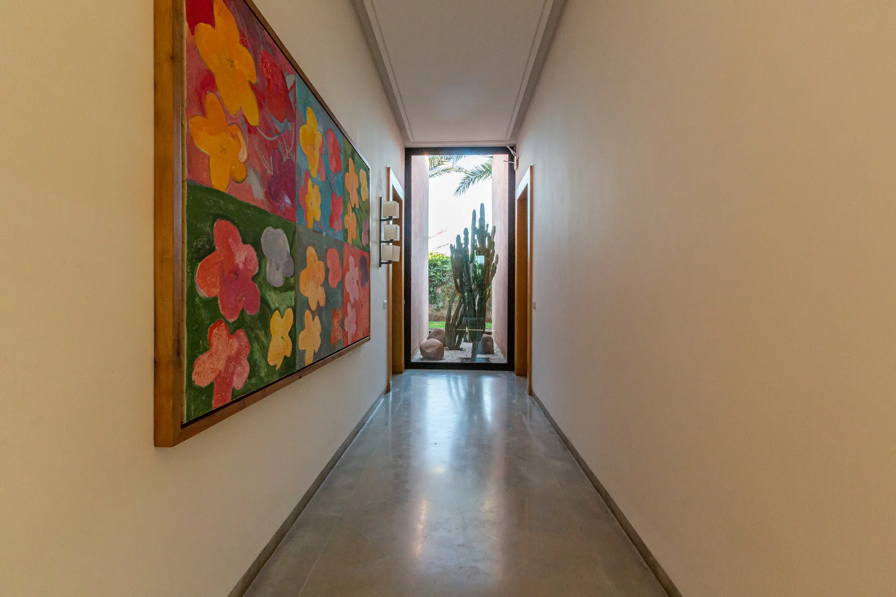 Villa Zephyra, 5 bedroom villa for rent in Marrakech, gallery corridor with colourful art. The Marrakech Curator.