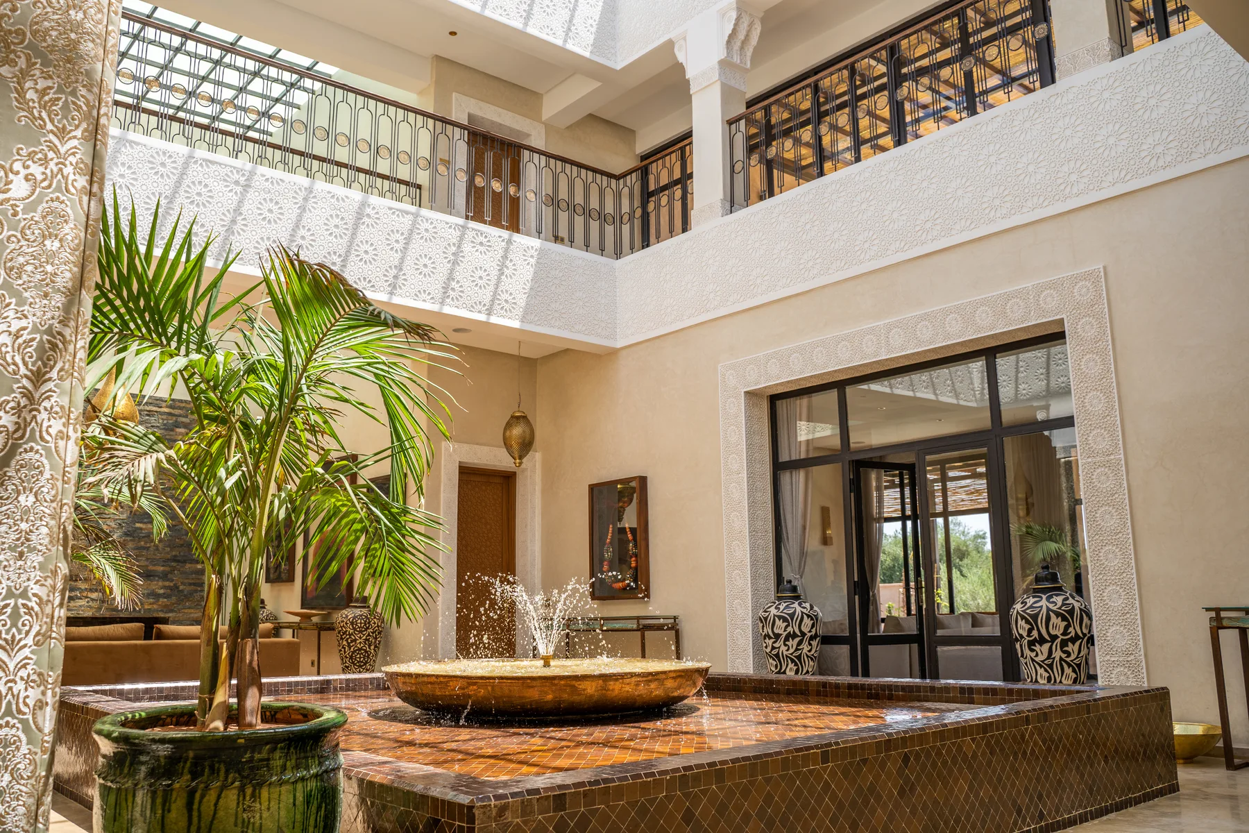 Villa Kallista, 12 bedroom wedding and event villa in Marrakech, courtyard fountain and greenery. The Marrakech Curator.