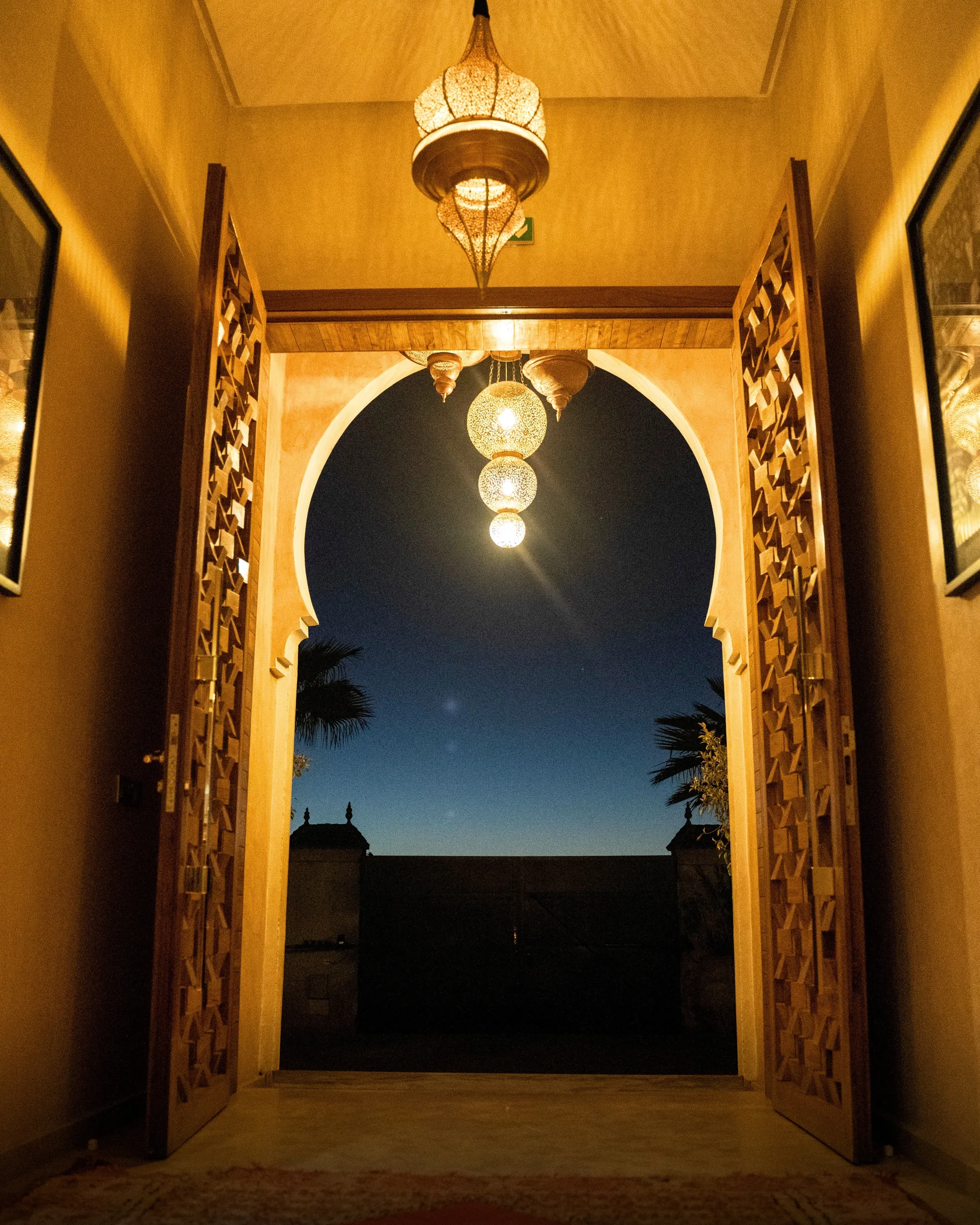 Villa Kallista, 12 bedroom wedding and event villa in Marrakech, entrance arch by night. The Marrakech Curator.